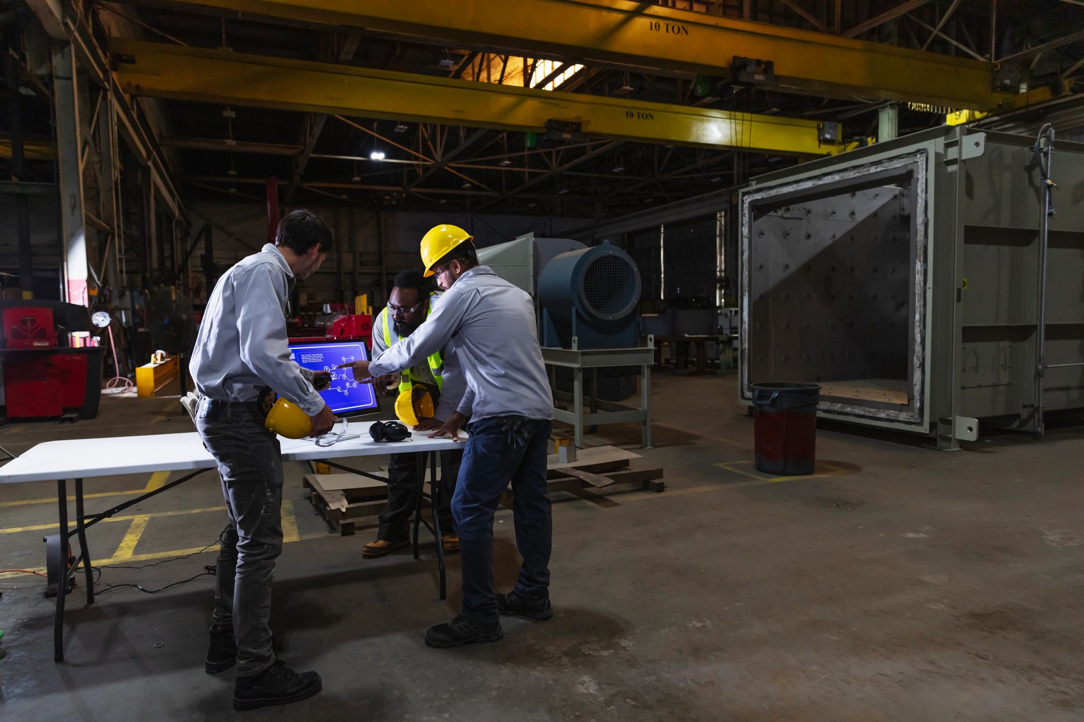 Workers discussing operations on a factory floor